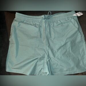 Green shorts with fake back pockets.
